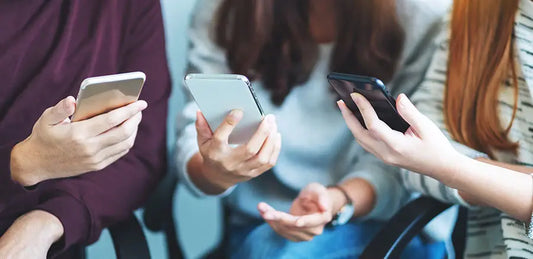 Customer reviewing Android smartphones before purchase at PayMore Seekonk